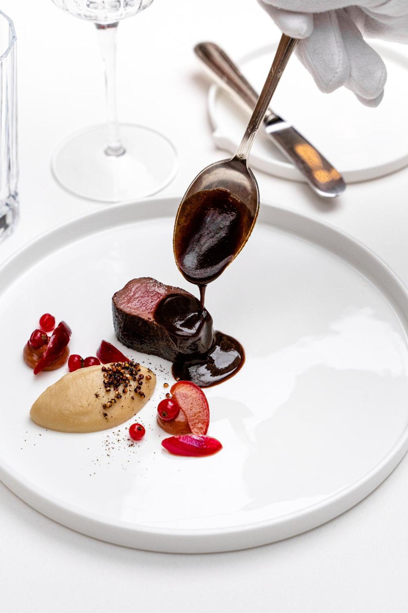 Stikliai Hotel - Relais & Chateaux Vilnius Ngoại thất bức ảnh A chocolate sauce being drizzled onto a dessert